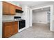 Cozy kitchen with a stove and tile flooring, next to an open living space at 506 7Th Sw St, Hickory, NC 28602