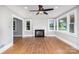 Bright living room with a fireplace, hardwood floors, and multiple windows offering ample natural light at 506 7Th Sw St, Hickory, NC 28602