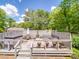 Backyard deck showcasing a hot tub, a gray privacy fence, a seating area, and mature landscaping at 5411 Valley Forge Rd, Charlotte, NC 28210