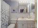 Cozy bathroom featuring blue walls, a decorative mirror, and a patterned shower curtain at 5411 Valley Forge Rd, Charlotte, NC 28210