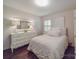 Bright bedroom featuring neutral tones, a white dresser, an accent mirror, and hardwood floors at 5411 Valley Forge Rd, Charlotte, NC 28210