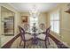 Charming dining room featuring hardwood floors, shuttered windows, and elegant chandelier lighting at 5411 Valley Forge Rd, Charlotte, NC 28210