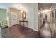 Hallway featuring hardwood floors, overhead lighting, and neutral wall colors at 5411 Valley Forge Rd, Charlotte, NC 28210