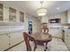 Cozy kitchen nook featuring a table and chairs, complemented by well-lit cabinetry and modern appliances at 5411 Valley Forge Rd, Charlotte, NC 28210