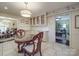 Bright kitchen showing cabinetry with glass fronts and a table, adjacent to the living room at 5411 Valley Forge Rd, Charlotte, NC 28210