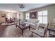 Bright living room boasts stylish furnishings, dark hardwood floors, and a view into the dining area at 5411 Valley Forge Rd, Charlotte, NC 28210