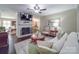 Spacious living room features a decorative fireplace, comfortable seating, and access to an adjoining room at 5411 Valley Forge Rd, Charlotte, NC 28210