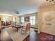 Inviting living room featuring elegant furniture, hardwood floors, and abundant natural light from shuttered windows at 5411 Valley Forge Rd, Charlotte, NC 28210