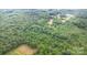 A sprawling aerial view showcases a property nestled among dense trees, close to nature and peacefulness at 5523 Flint Ridge Church Rd, Marshville, NC 28103