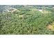 A scenic aerial view reveals a secluded property enveloped by verdant trees, offering ultimate privacy at 5523 Flint Ridge Church Rd, Marshville, NC 28103