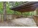 Large wooden back deck surrounded by lush greenery, perfect for outdoor relaxation at 5523 Flint Ridge Church Rd, Marshville, NC 28103
