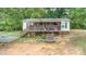 Back exterior view highlighting the deck, backyard with trampoline, and landscaping at 5523 Flint Ridge Church Rd, Marshville, NC 28103