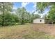 Overview of the backyard, showing the house, trees, and a playground area at 5523 Flint Ridge Church Rd, Marshville, NC 28103