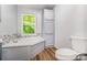 Relaxing bathroom with a soaking tub and a view of the lush greenery outside at 5523 Flint Ridge Church Rd, Marshville, NC 28103