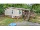 Exterior view showcasing the back of the house with deck, stairs, and partial brick foundation at 5523 Flint Ridge Church Rd, Marshville, NC 28103