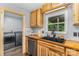 Kitchen view with stainless steel appliances, custom wood cabinets, and an adjacent laundry room at 5523 Flint Ridge Church Rd, Marshville, NC 28103