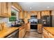 The kitchen has custom wood cabinets, stainless steel appliances, and modern countertops at 5523 Flint Ridge Church Rd, Marshville, NC 28103