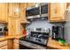 Close-up of the kitchen with stainless steel appliances, wood countertops, and custom cabinets at 5523 Flint Ridge Church Rd, Marshville, NC 28103