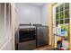 Modern laundry room featuring stainless steel washer and dryer at 5523 Flint Ridge Church Rd, Marshville, NC 28103