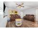 Spacious living room with wood-look flooring, comfortable seating, and a ceiling fan at 5523 Flint Ridge Church Rd, Marshville, NC 28103