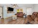 Inviting living room with wood-look flooring, plush seating, and plenty of natural light at 5523 Flint Ridge Church Rd, Marshville, NC 28103