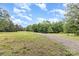 Long gravel driveway leading through the property, surrounded by trees and open land at 5523 Flint Ridge Church Rd, Marshville, NC 28103