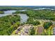 Stunning aerial view of lakefront homes surrounded by lush trees and serene water at 6136 Sandy Point Ln, Belmont, NC 28012