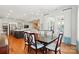 Bright dining room features hardwood floors, modern lighting, and access to the kitchen and outdoor living areas at 6136 Sandy Point Ln, Belmont, NC 28012