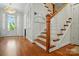 Welcoming entryway featuring hardwood floors and a staircase with wooden banister and white spindles at 6136 Sandy Point Ln, Belmont, NC 28012