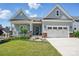 Charming home featuring a manicured lawn, welcoming front porch, and attached two-car garage at 6136 Sandy Point Ln, Belmont, NC 28012