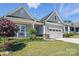 Beautiful home exterior with well-maintained landscaping, a covered porch, and a two-car garage at 6136 Sandy Point Ln, Belmont, NC 28012
