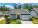 Lovely single-Gathering home with a welcoming front porch, two-car garage, and professionally landscaped yard at 6136 Sandy Point Ln, Belmont, NC 28012