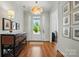 Elegant foyer featuring hardwood floors, a stylish light fixture, and tasteful decor at 6136 Sandy Point Ln, Belmont, NC 28012