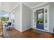Inviting front porch with a comfortable seating area and a stylish blue front door with sidelights at 6136 Sandy Point Ln, Belmont, NC 28012