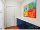 Hallway featuring built-in blue cabinetry with white countertop and colorful dog artwork on the wall at 6136 Sandy Point Ln, Belmont, NC 28012