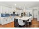 Modern kitchen with white cabinets, subway tile backsplash, stainless steel appliances, and center island at 6136 Sandy Point Ln, Belmont, NC 28012