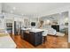 Open kitchen featuring stainless steel appliances, hardwood flooring and an open floor-plan to the living room at 6136 Sandy Point Ln, Belmont, NC 28012