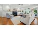 Comfortable living room showcasing a fireplace, built-in storage, and hardwood floors bathed in natural light at 6136 Sandy Point Ln, Belmont, NC 28012