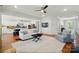 Bright, open living room featuring white sofa and hardwood floors flowing into an open floor-plan kitchen at 6136 Sandy Point Ln, Belmont, NC 28012