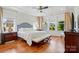 Spacious main bedroom offers ample natural light, tray ceiling, and hardwood floors at 6136 Sandy Point Ln, Belmont, NC 28012