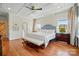 Beautiful main bedroom features tray ceiling, multiple windows, and hardwood floors at 6136 Sandy Point Ln, Belmont, NC 28012