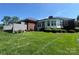 Spacious backyard with a mix of brick and siding exterior, and a well-maintained lawn at 6339 River Front Dr, Harrisburg, NC 28075