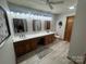 Bathroom featuring a long vanity with double sinks, gray walls, and modern fixtures at 6339 River Front Dr, Harrisburg, NC 28075