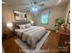 Inviting bedroom with neutral walls, modern decor, and warm lighting at 6339 River Front Dr, Harrisburg, NC 28075
