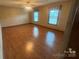 Spacious bedroom with a ceiling fan, neutral walls, and hardwood flooring creates a comfortable, airy space at 6339 River Front Dr, Harrisburg, NC 28075