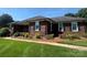 Charming brick ranch-style home with a well-manicured lawn and mature landscaping at 6339 River Front Dr, Harrisburg, NC 28075