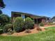 Inviting brick ranch-style home with mature trees and a well-kept lawn at 6339 River Front Dr, Harrisburg, NC 28075