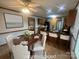 Charming dining area adjacent to kitchen with bar seating, dark granite countertops, and neutral color palette at 6339 River Front Dr, Harrisburg, NC 28075