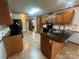 Functional kitchen offers warm cabinets, tile floors, and plenty of counter space at 6339 River Front Dr, Harrisburg, NC 28075