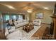 Cozy living room features fireplace, comfortable seating, and open floor plan at 6339 River Front Dr, Harrisburg, NC 28075